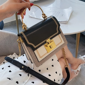 Chic monochrome crossbody bag with gold metal handle and woven texture detail
