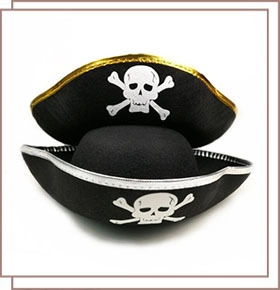 Close-up of black felt pirate hats with white skull patterns and gold or silver trim
