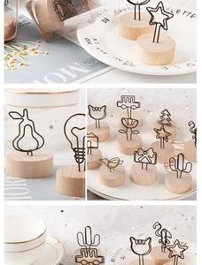 Close-up of assorted wood base memo holders in shapes of star, bird, and camera