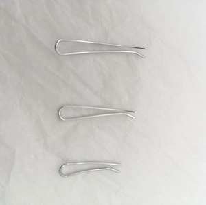 Three sizes of silver U-shaped metal hair clips displayed on a white textured background