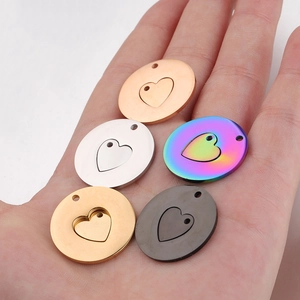 Five assorted mirrored stainless steel hollow heart pendants in various metallic colors