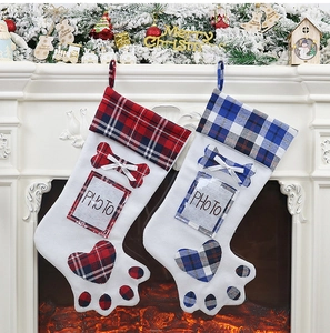 Detail of red and blue plaid dog paw Christmas stockings with clear photo pockets