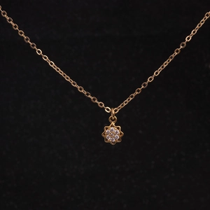 Macro detail of gold-plated necklace with sparkling star pendant and pavé zircon stones