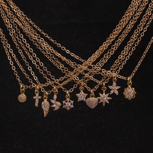 Golden flower necklace with heart and star zircon pendants on fine minimalist chains