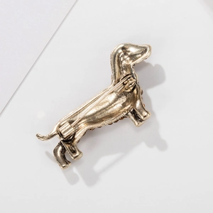 Back view of retro dachshund brooch in antique gold finish with safety pin clasp