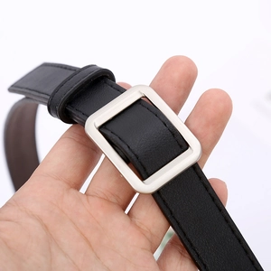 Minimalist black leather belt with a square silver buckle and elegant stitching