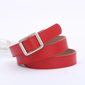 Detail of red leather belt with silver square metal buckle and fine texture finish