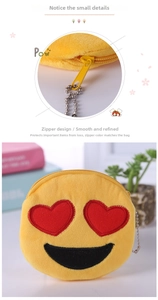 Detailed close-up of yellow emoji plush coin purse with embroidery and metal chain