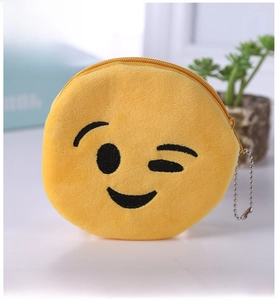 Close-up of yellow plush wink emoji coin purse with black embroidery and bead chain