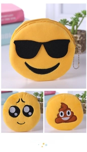 Detail of yellow plush emoji coin purses with embroidery and metal ball chain hangers