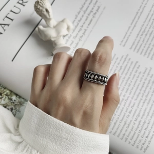 Macro shot of a retro S925 silver twist rope ring with vintage industrial texture