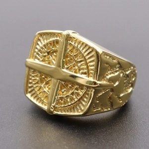 Close-up of golden Masonic ring featuring intricate compass and cross relief details