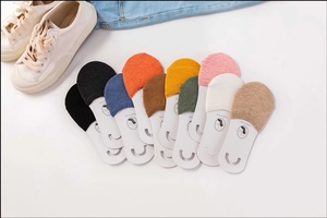 Flat lay display of colorful cotton invisible socks with casual canvas shoes nearby