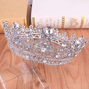 Macro detail of luxury silver Baroque bridal crown with crystals on vintage books