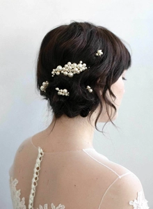 Detail of bridal hair pin set with vintage Baroque pearls on an elegant hair updo