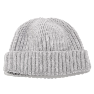 Close-up of light gray ribbed knit beanie showing soft texture and folded brim detail