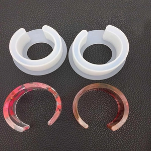 Macro detail of oval C-shape resin bracelet silicone molds and sample resin bangles