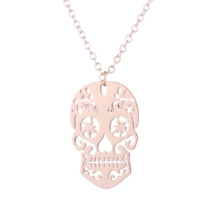 Detailed view of rose gold hollow skull pendant with fine chain on white background