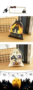 Detail of Halloween drawstring candy bags featuring black cat and pumpkin prints on fabric
