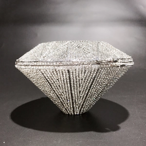Detailed view of silver diamond-shaped evening clutch bag with full crystal embellishment