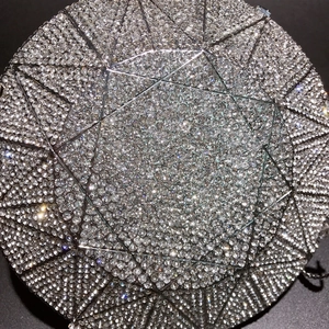 Macro view of geometric crystal pattern on silver sparkling evening clutch bag