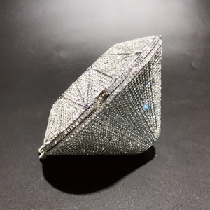 Detailed view of silver crystal diamond-shaped clutch bag with sparkling rhinestones