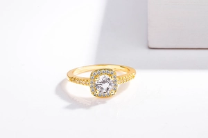 Macro shot of gold halo ring with round center stone and pave-set diamond accents