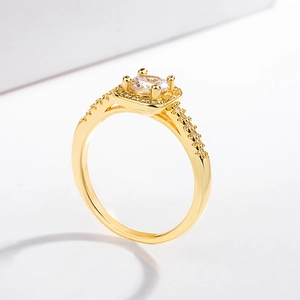 Macro shot of gold square zircon ring featuring micro-pave side stones and polished finish