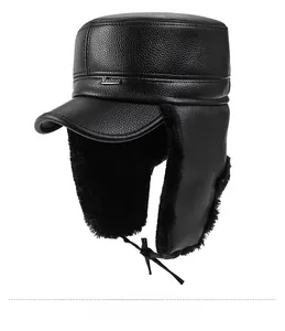 Detail view of winter trapper hat showing black litchi texture leather and warm faux fur