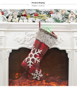 Classic Christmas stocking with red-green plaid, white snowflake, and grey faux fur detail