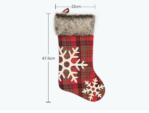 Detail of red plaid Christmas stocking with snowflakes and faux fur trim, 47.5cm tall