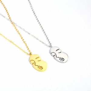 Abstract face profile necklaces in gold and silver finish on minimalist steel chains