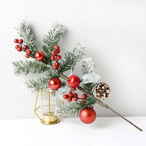 Artificial pine branch with red berries and snowy pinecones for Christmas decor