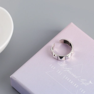 Macro shot of S925 sterling silver minimalist stud ring on a purple gift box