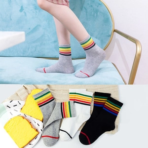 Detail of cotton crew socks with rainbow stripes in grey white and black colors