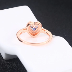 Detail of rose gold heart-shaped ring featuring pavé setting and hollow back design