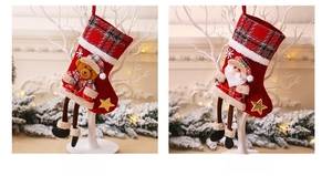 Detailed view of red plaid Christmas stockings with cute bear and Santa hanging ornaments