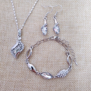 Detailed view of silver crystal jewelry set including necklace, earrings, and bracelet