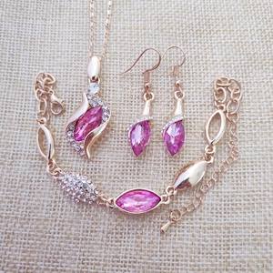 Detail of rose gold jewelry set with pink stones and sparkling crystal accents