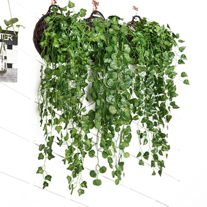 Detailed view of three wall-hanging artificial succulent vines with lush green leaves