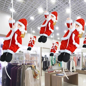Detail of hanging Santa Claus climbing a rope with a golden gift bag for holiday decor