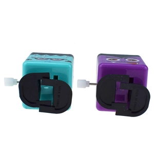 Detail of teal and purple wind-up monster toys with mechanical walking base for Halloween
