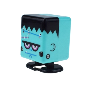 Detail of blue Frankenstein wind-up toy showing square head and purple monster eyes