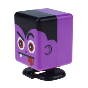 Detail shot of purple vampire wind-up toy with square face and fang expression for Halloween