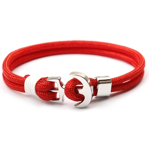 Red braided paracord anchor bracelet with silver alloy nautical hook clasp on white background