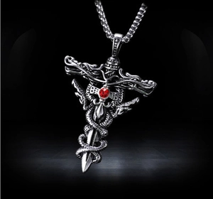 Detailed close-up of a silver hip-hop sword pendant with a red gemstone and snake