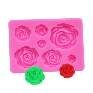 Detailed pink silicone mold featuring rose patterns with red and green finished samples