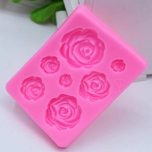 Detailed macro view of pink silicone mold with seven rose flower shapes for baking decoration