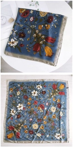 Detail of floral printed square silk scarf in misty blue with fine hemmed edges