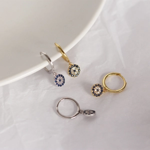 Close-up of S925 silver Evil Eye hoop earrings with sparkling blue and clear crystals